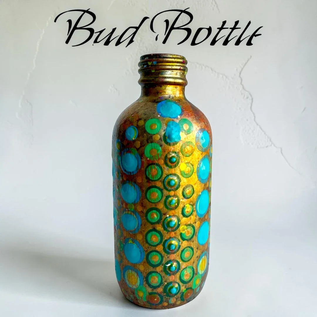 A 4-ounce glass bottle which has been hand-painted and embossed by Color Cult.
