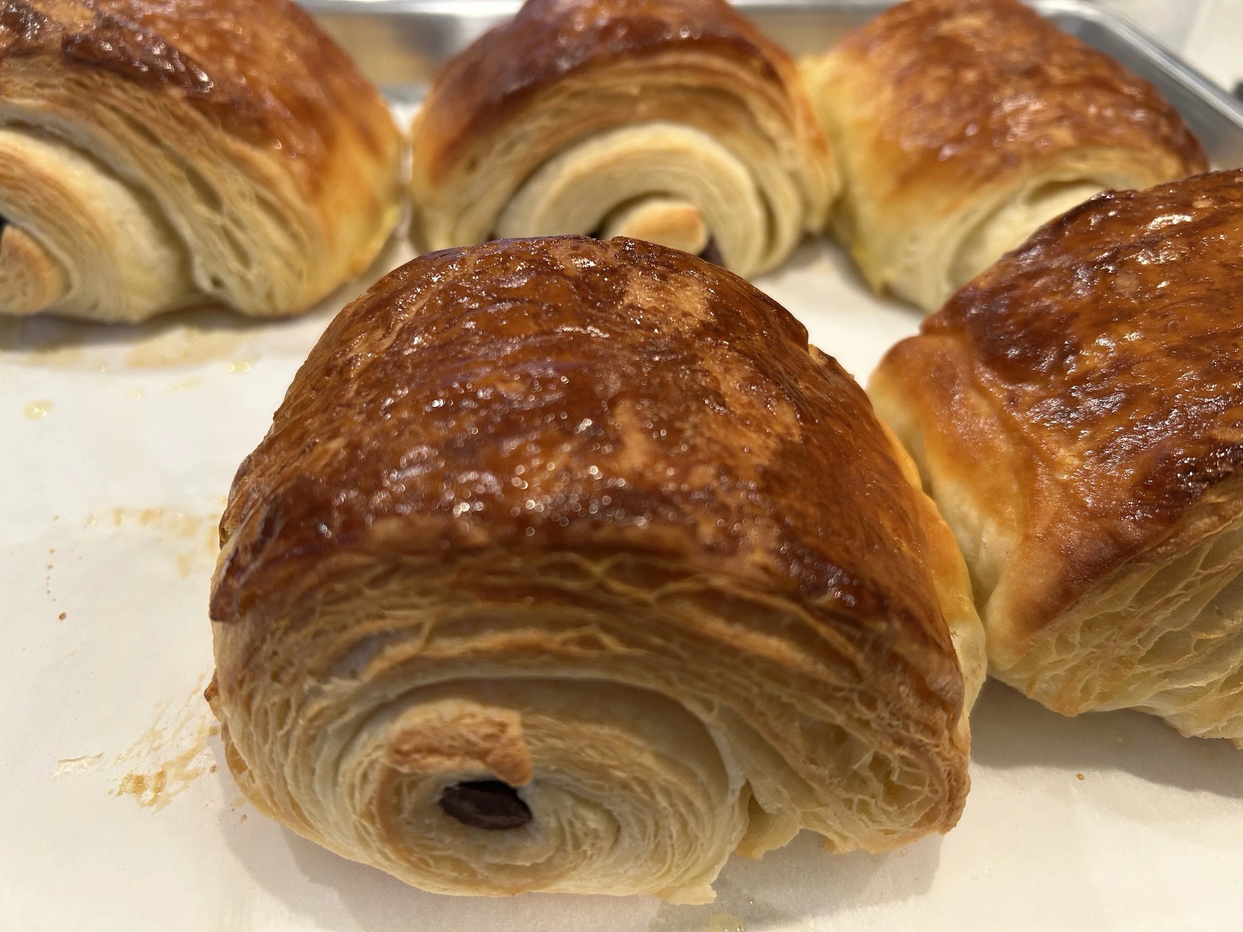Close-up of unbaked croissants on a baking sheet.