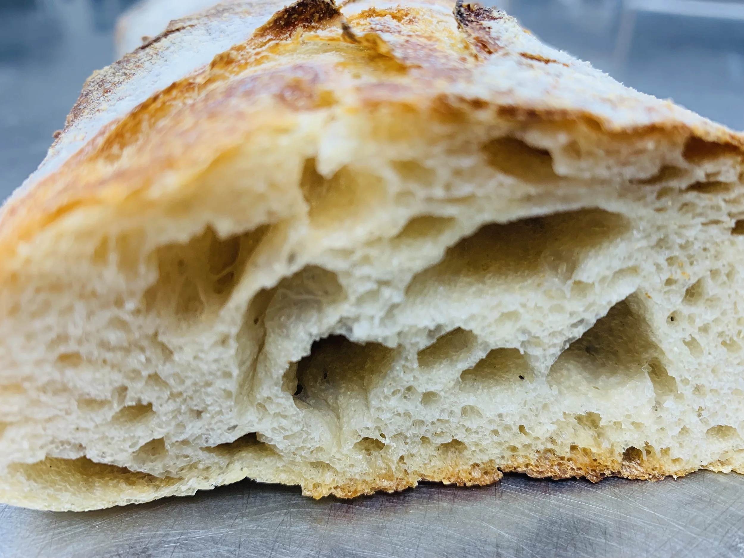 A close-up of a slice of bread showing the inside texture and crust.