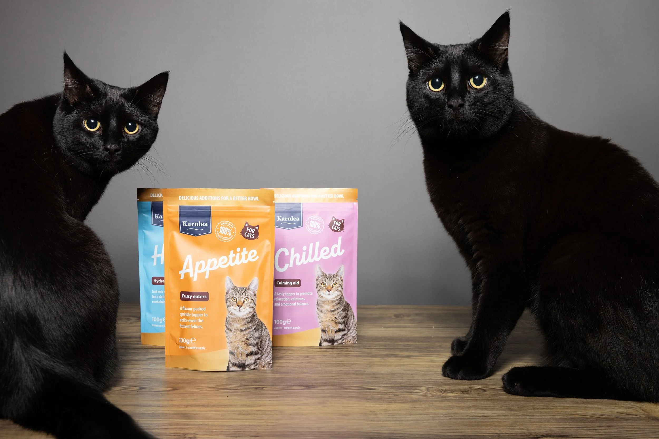Black cat posing with Karnlea product
