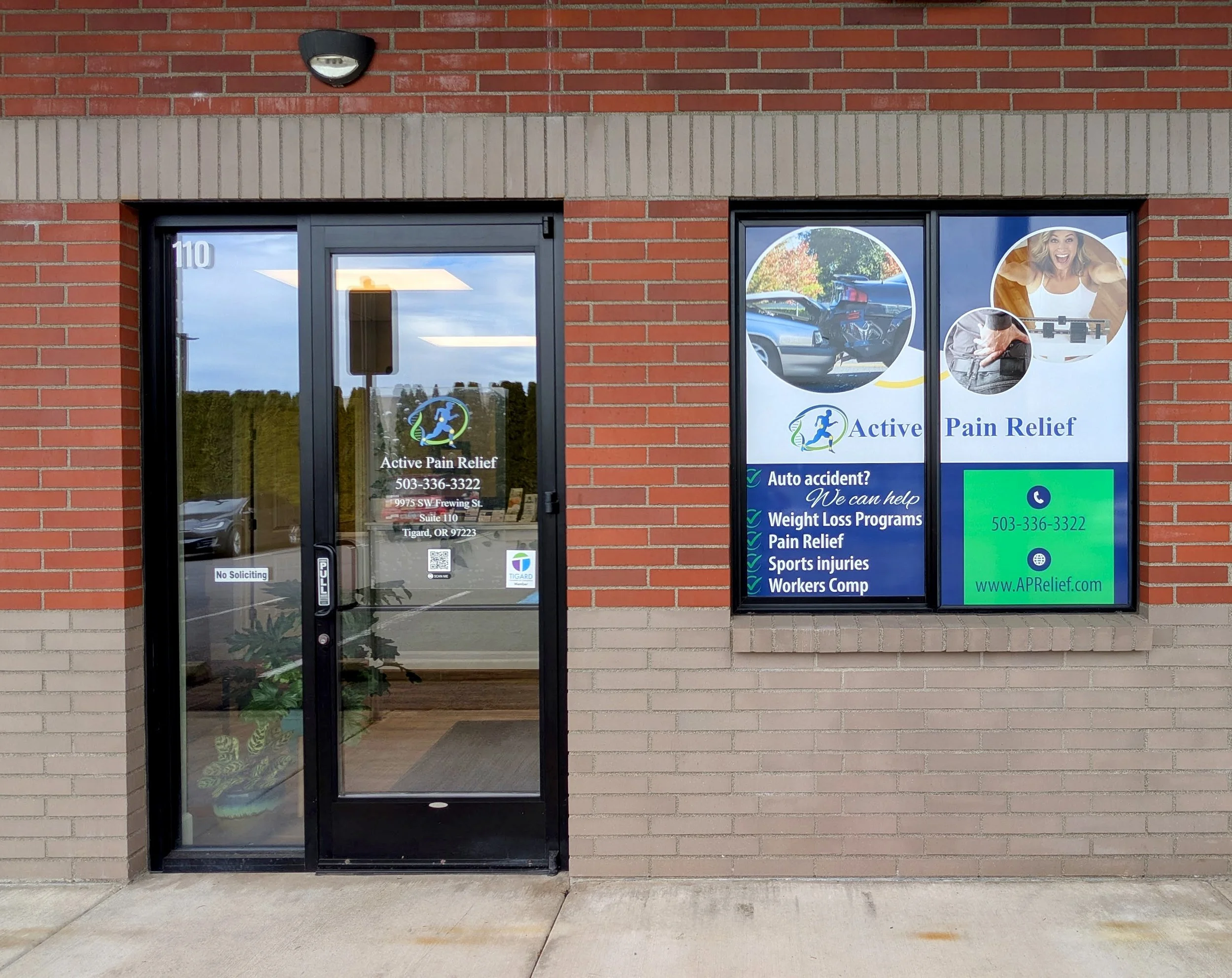 Entrance to Wise Touch Bodywork in Tigard, located inside the Active Pain Relief & Wellness building with glass double doors and brick exterior.