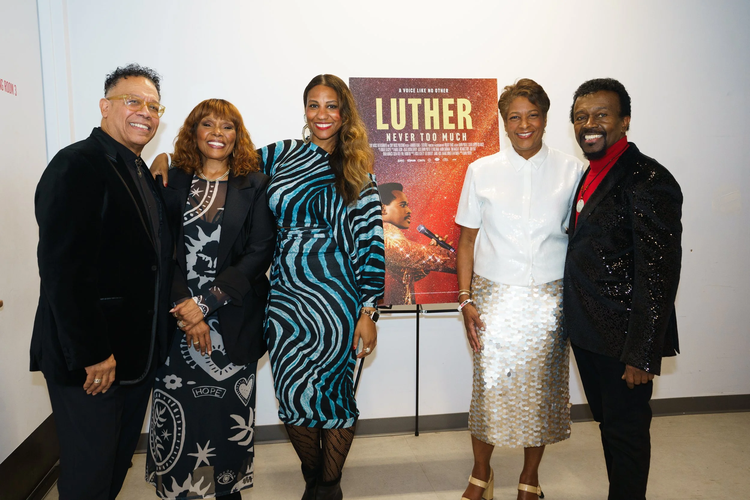  Folks standing in front of the film poster 