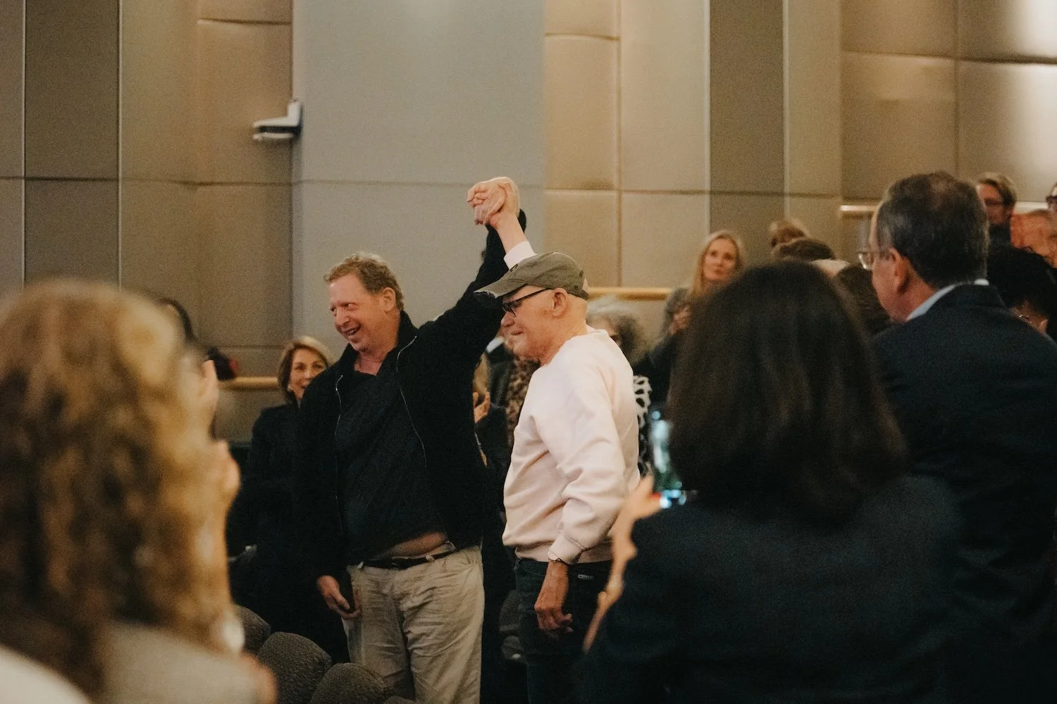  Filmmaker Matt Tyrnauer holding James Carville’s fist in the air 