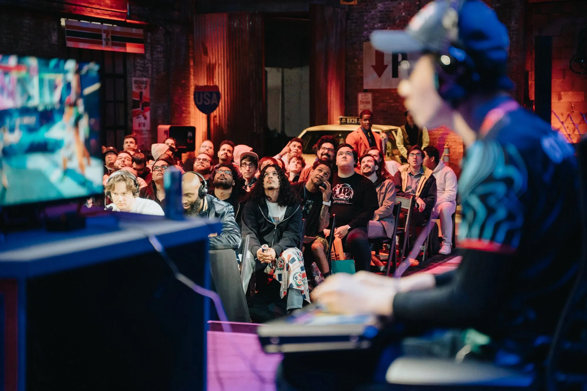 Fans watching tournament, player in the foreground