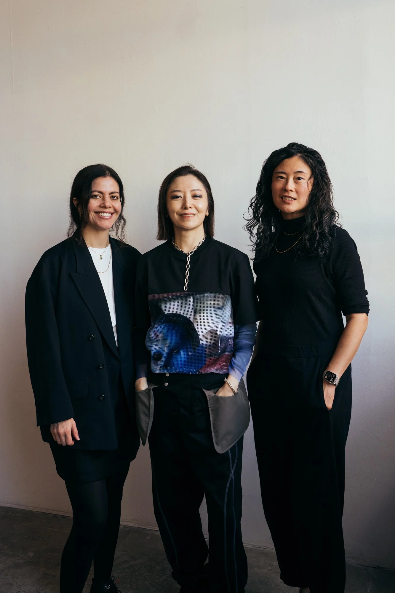 Three adult women smiling for the camera
