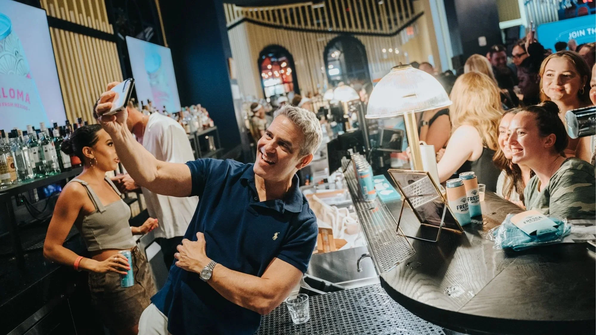 Andy Cohen taking a selfie with fans