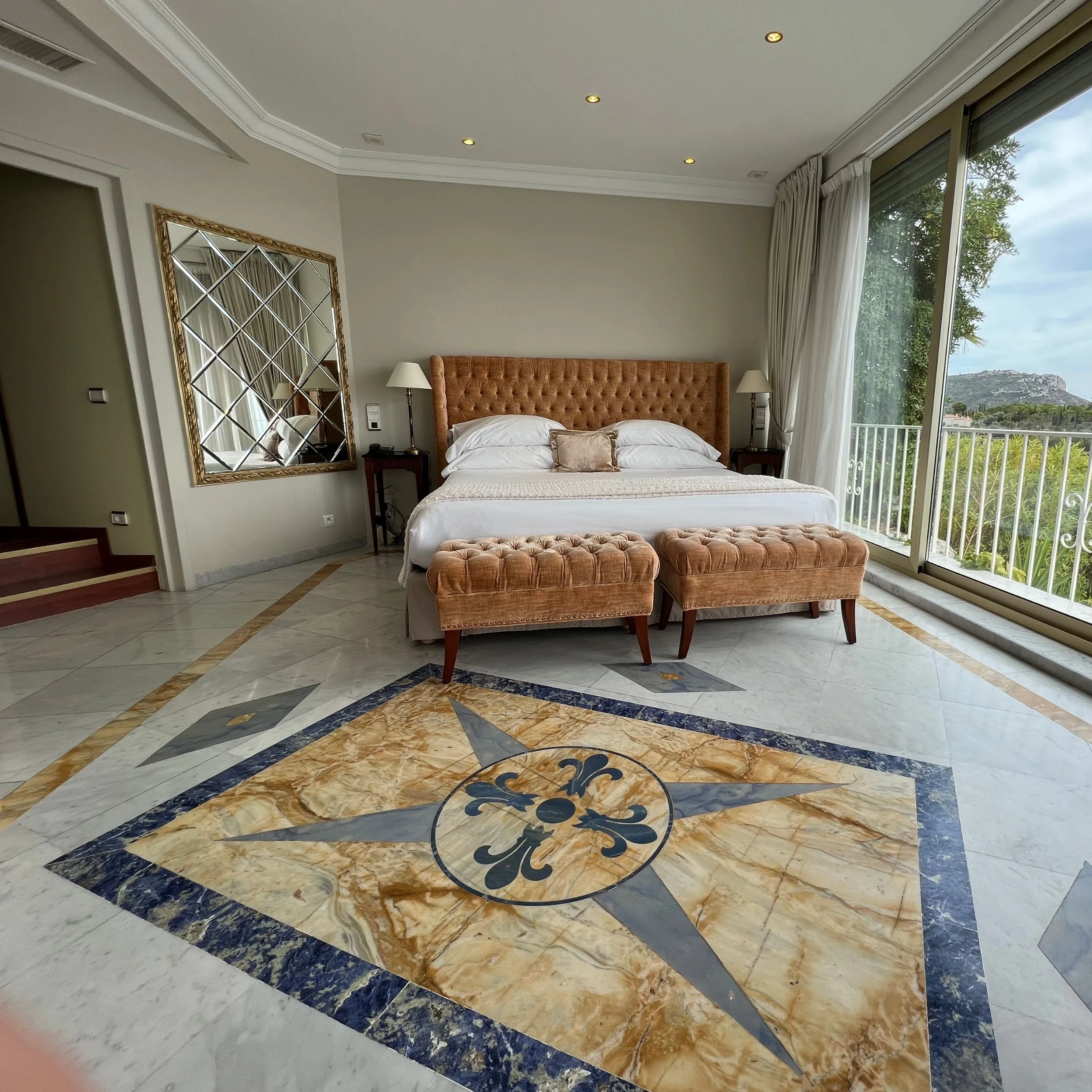 Bedroom of the Panoramic Suite with sea view at Château de la Chèvre d’Or in Èze