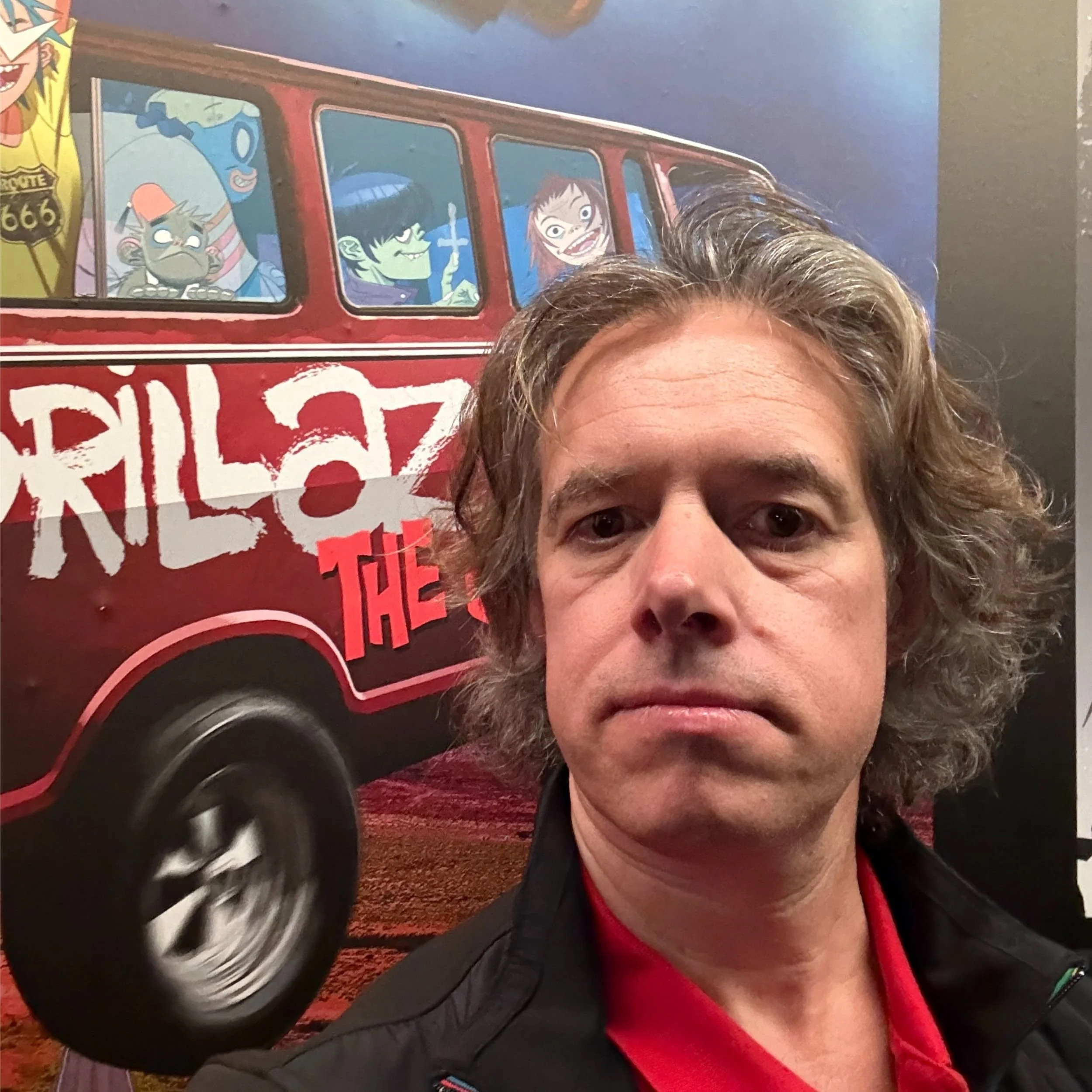 Jamie Riddell inside House of Kong exhibition beside Gorillaz red tour van artwork