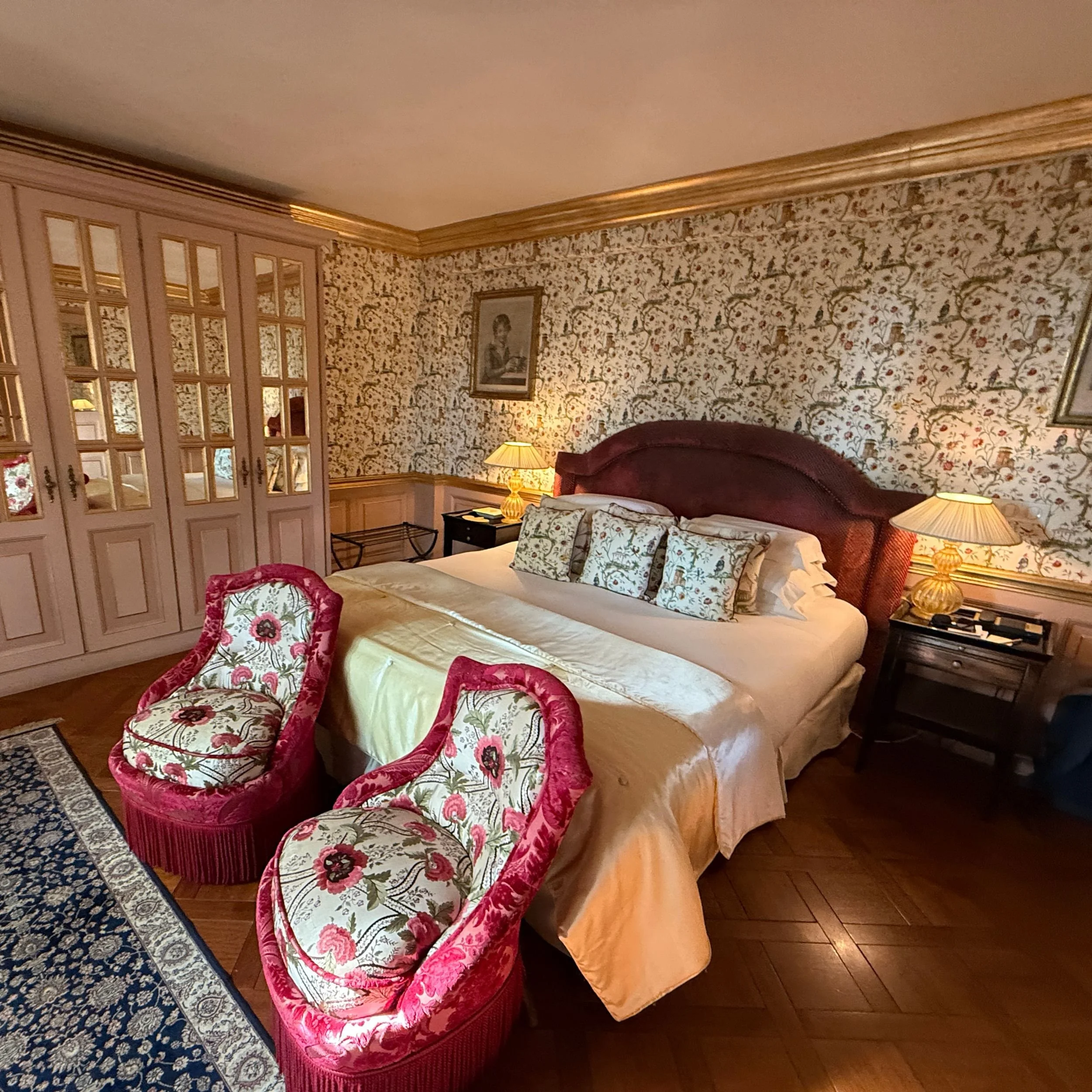 Bedroom in the Terrace Suite at Villa Gallici in Aix-en-Provence with floral fabrics and upholstered chairs