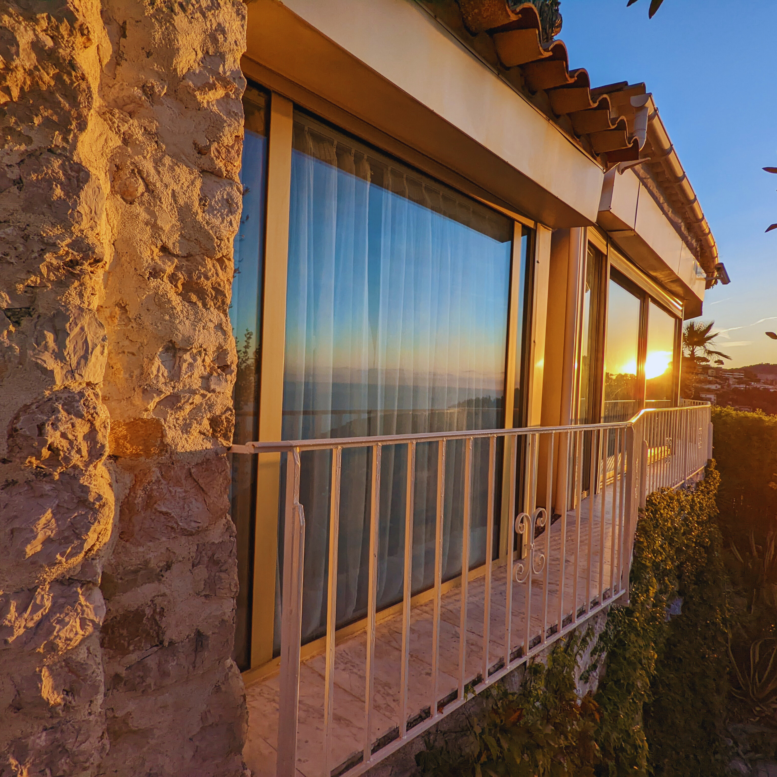 Sunset on the bedroom window in the Panoramic suite Chèvre D'Or.png