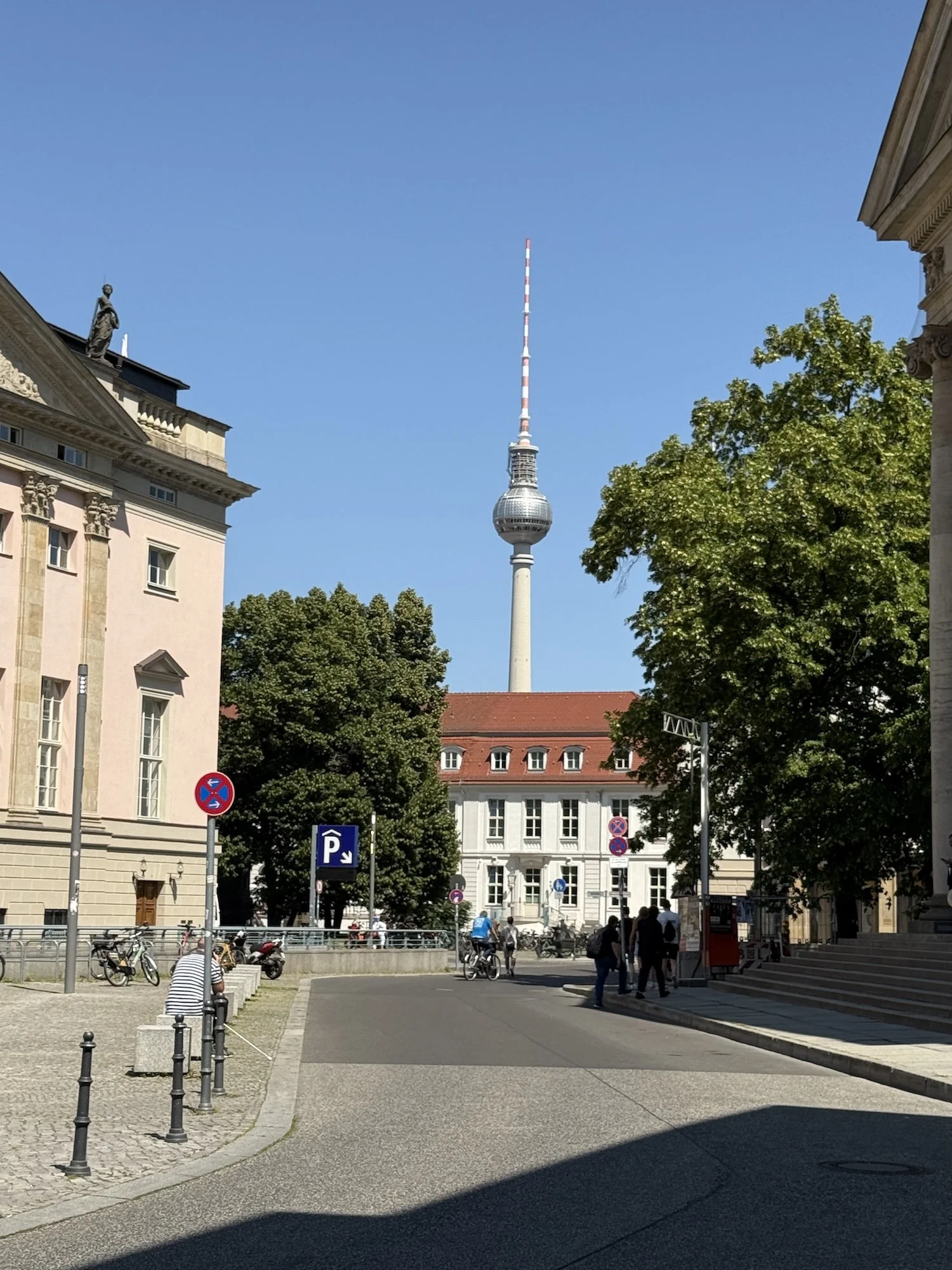 Berlin TV Tower from the steps of Hotel de Rome against a blue sky