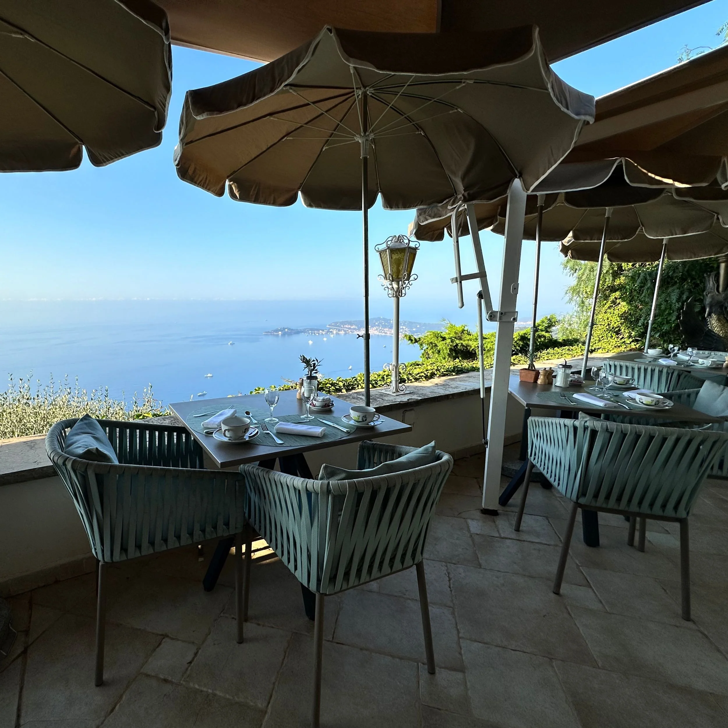 Breakfast seating on the Les Remparts terrace at Château de la Chèvre d’Or in Èze