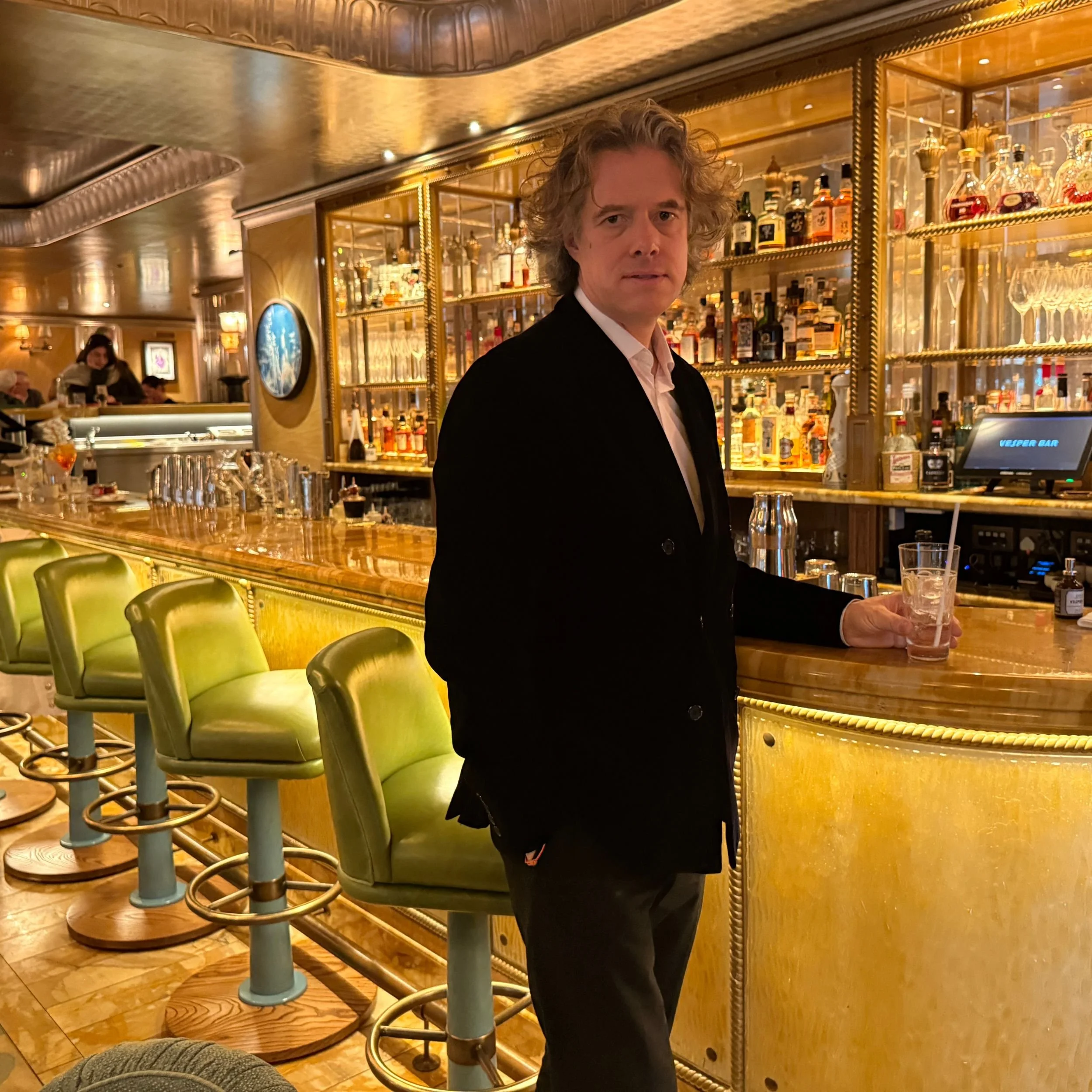 The handsome author stands at the Vesper Bar in the Dorchester Hotel.jpg