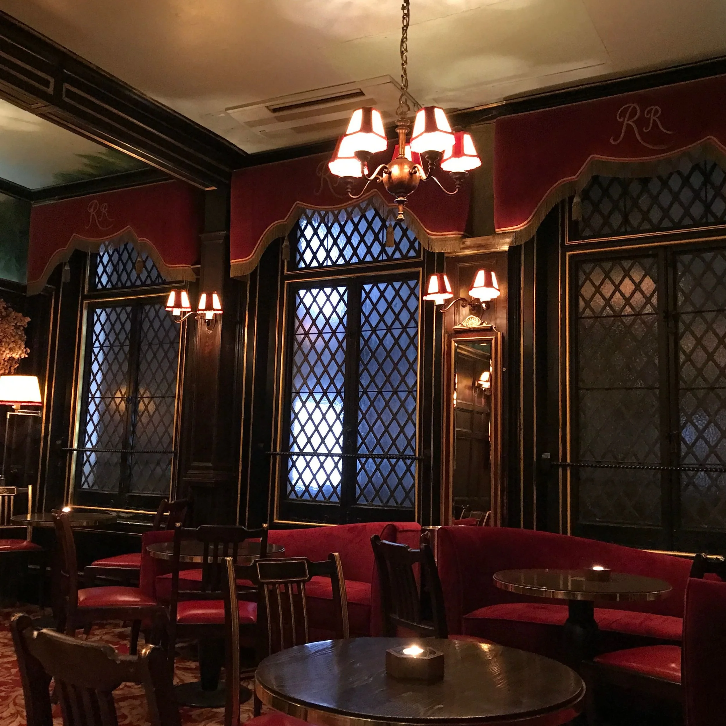 Inside Rules Restaurant showing the historic lattice windows and rich velvet curtains