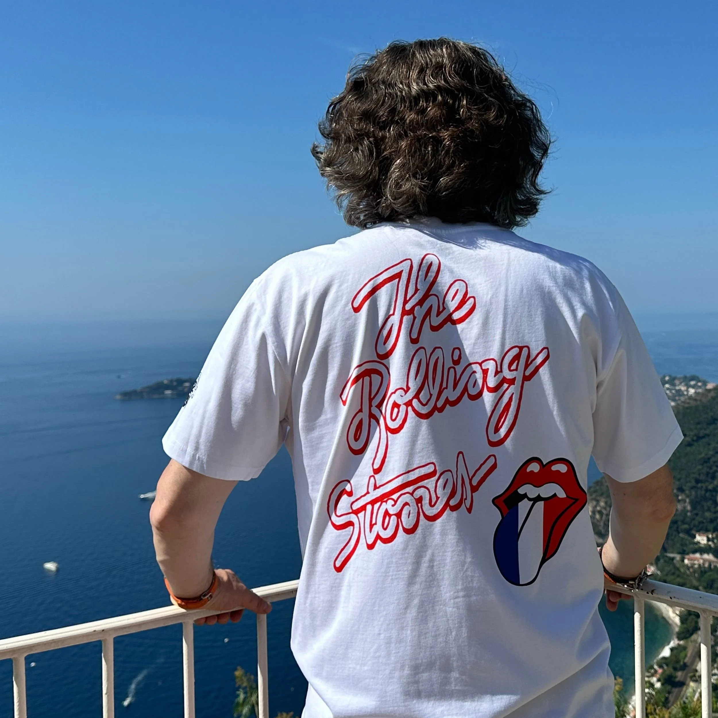 Jamie admires the view over the French Riviera from Château de la Chèvre d’Or in Èze wearing Footpatrol x The Rolling Stones Access Paris t-shirt