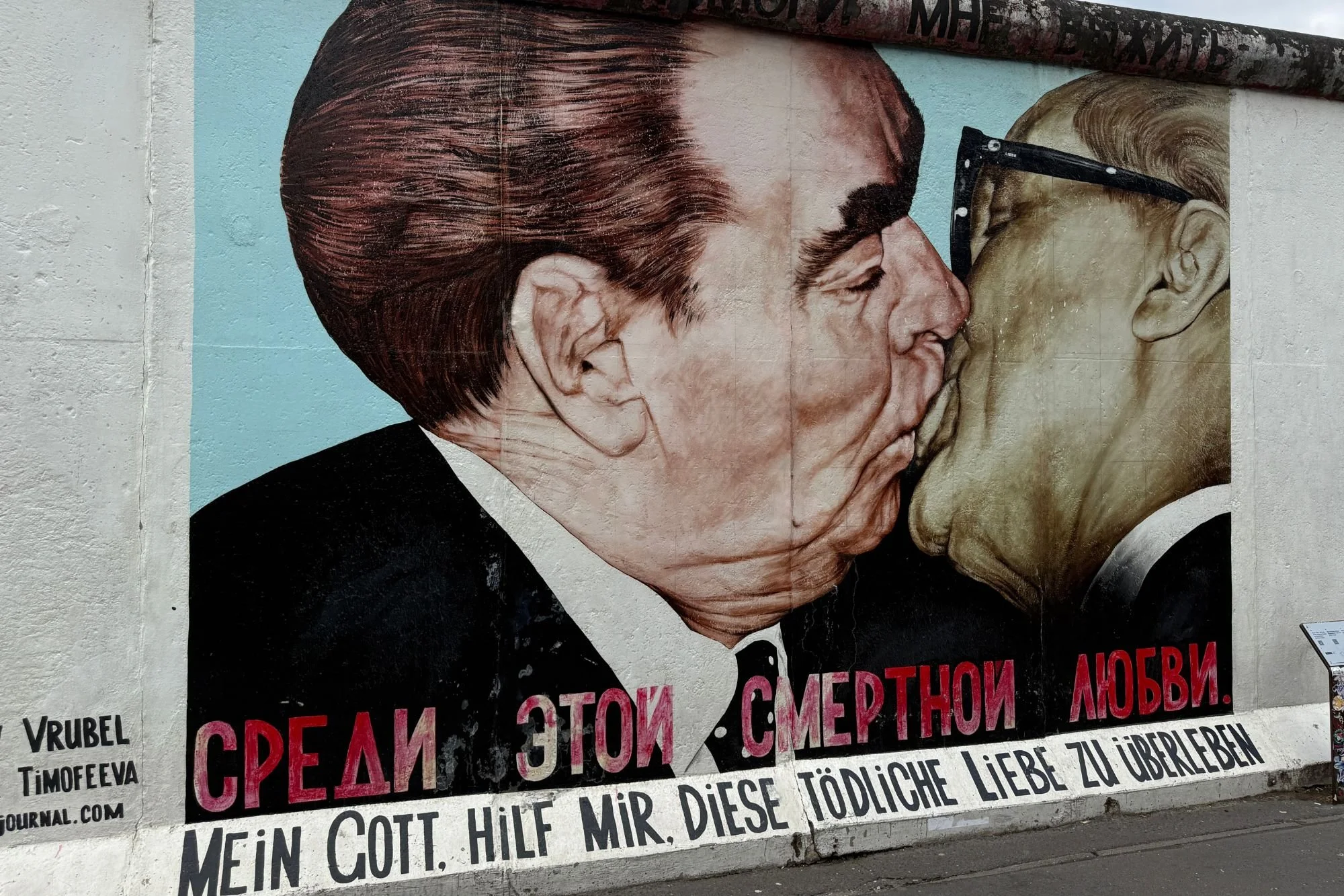 A detailed look at the iconic Brezhnev Kiss mural (My God, Help Me to Survive This Deadly Love) by Dmitri Vrubel on the Berlin Wall.
