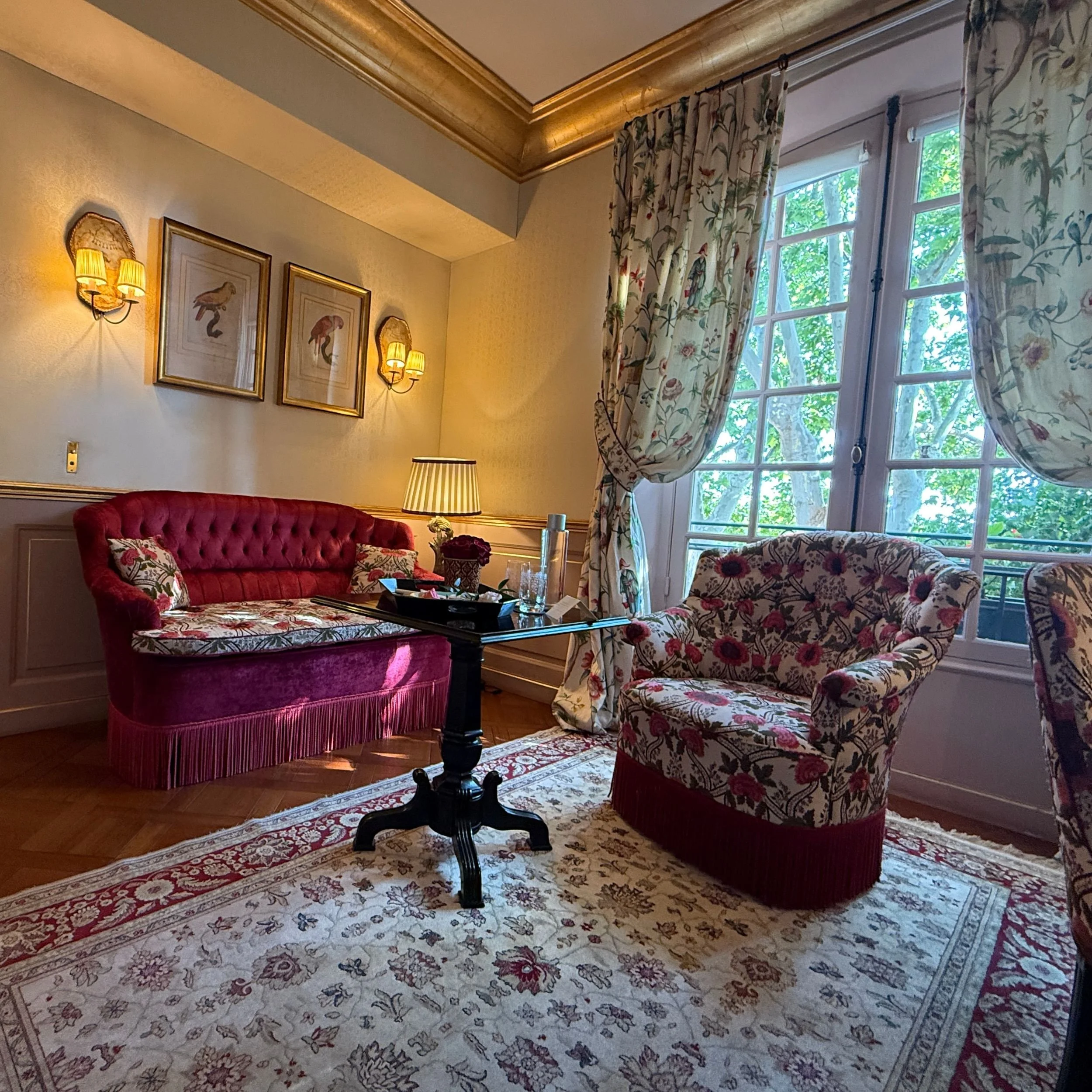 Living area in the Terrace Suite at Villa Gallici in Aix-en-Provence with sofa, armchairs and garden views