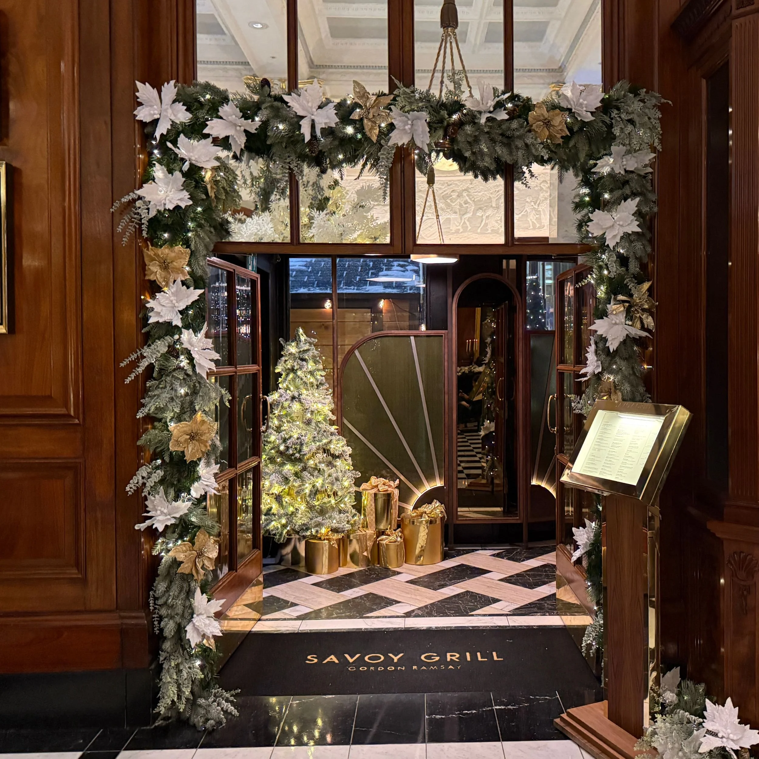 Entrance to the Savoy Grill restaurant decorated for Christmas 2025