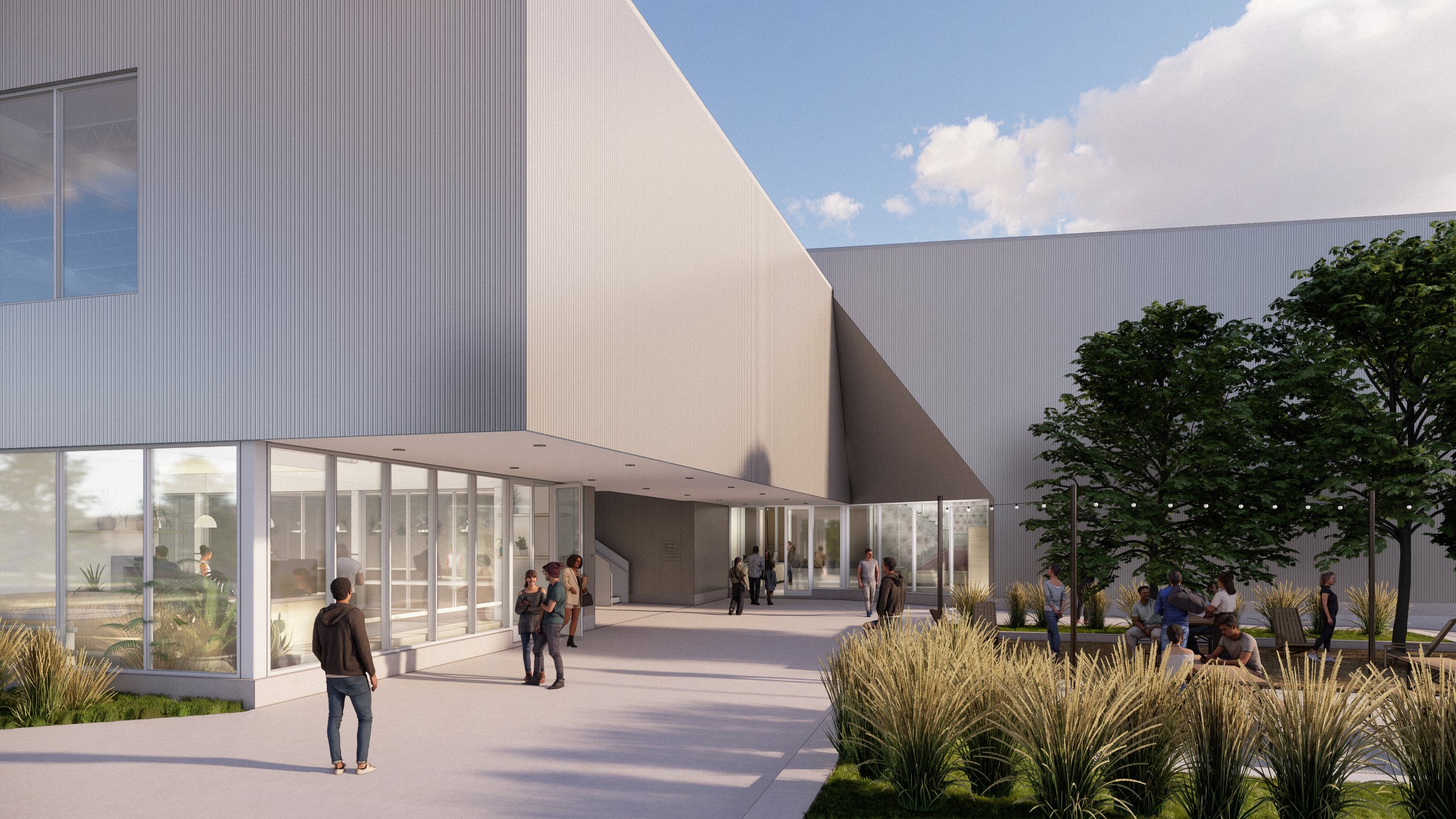 A cantilevered shade volume connects the entry to parking and frames the adjacent courtyard, transforming a simple circulation path into a social hub at the heart of the campus.