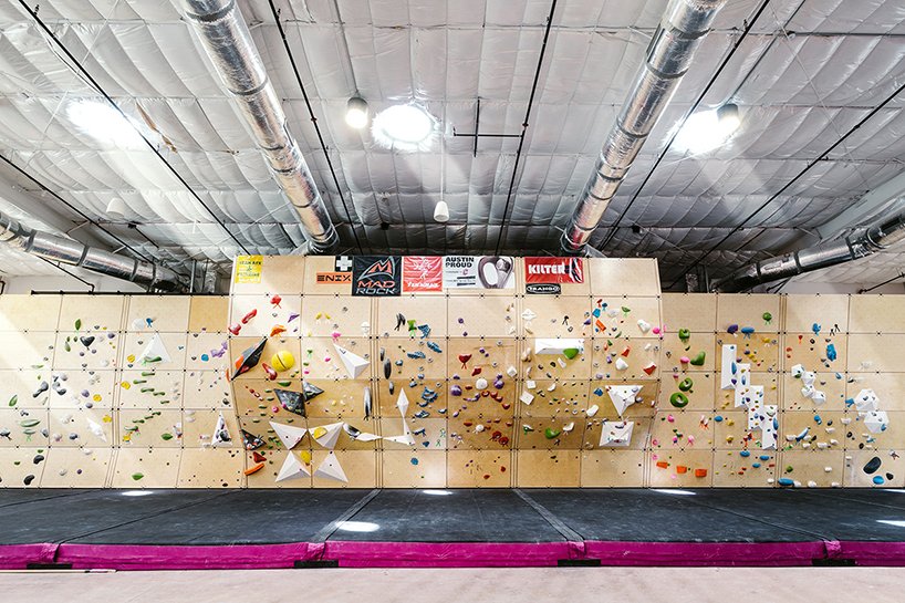 A panoramic Future Wall spans the length of the space, framed by exposed ductwork and daylighting, offering climbers a clear view of their next move.