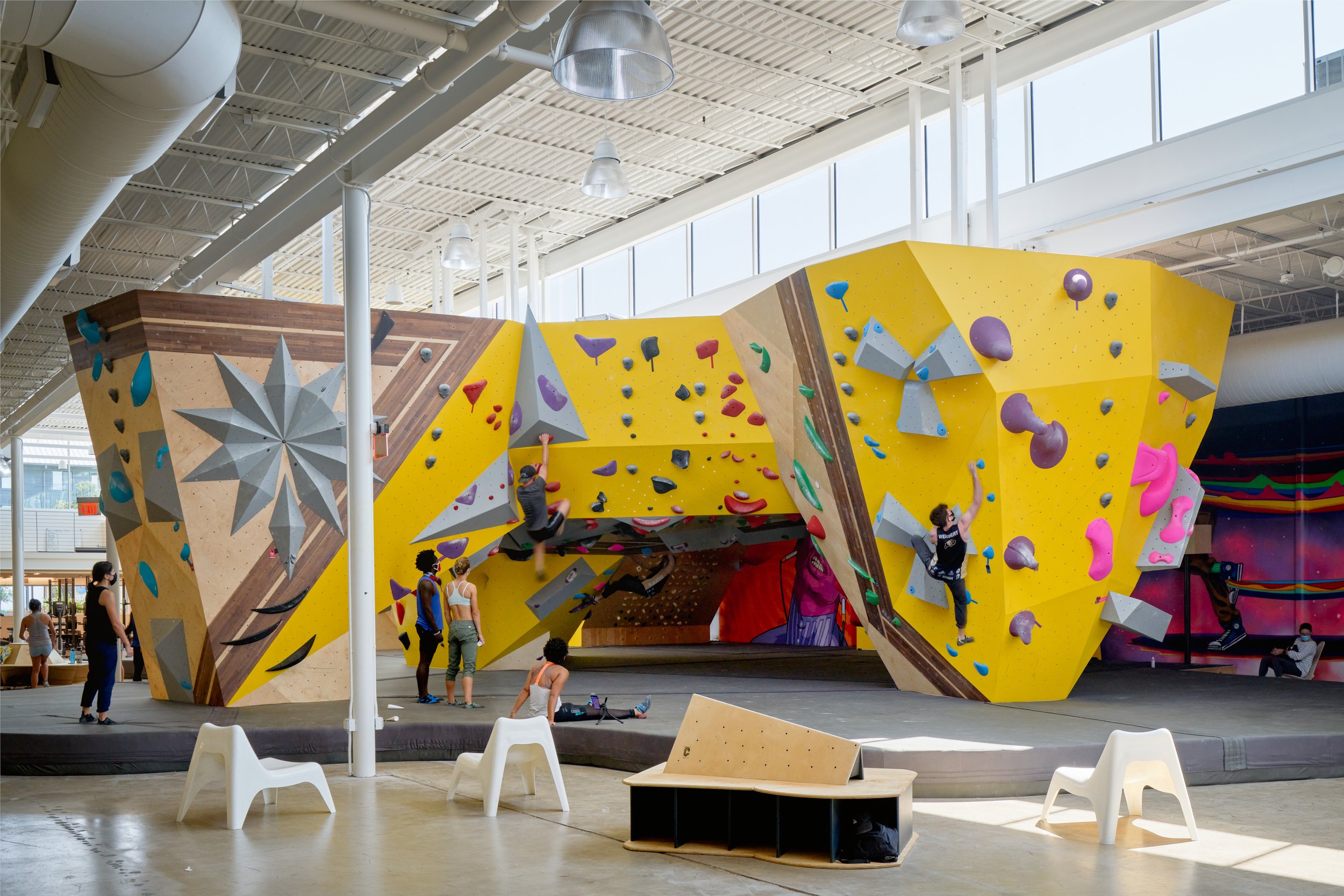 A bright, immersive corner of Crux Central where layered wall textures, playful holds, and bold murals converge—designed for both performance and visual delight.