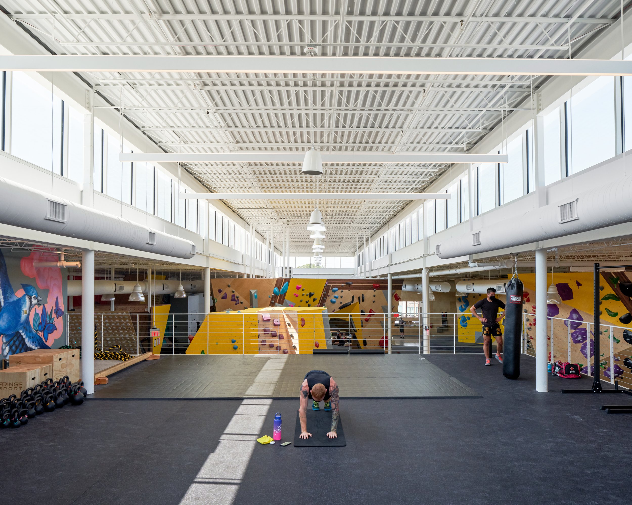 From the mezzanine gym, users get a full view of the climbing floor. Continuous clerestory glazing and exposed structure reinforce the sense of openness and movement.