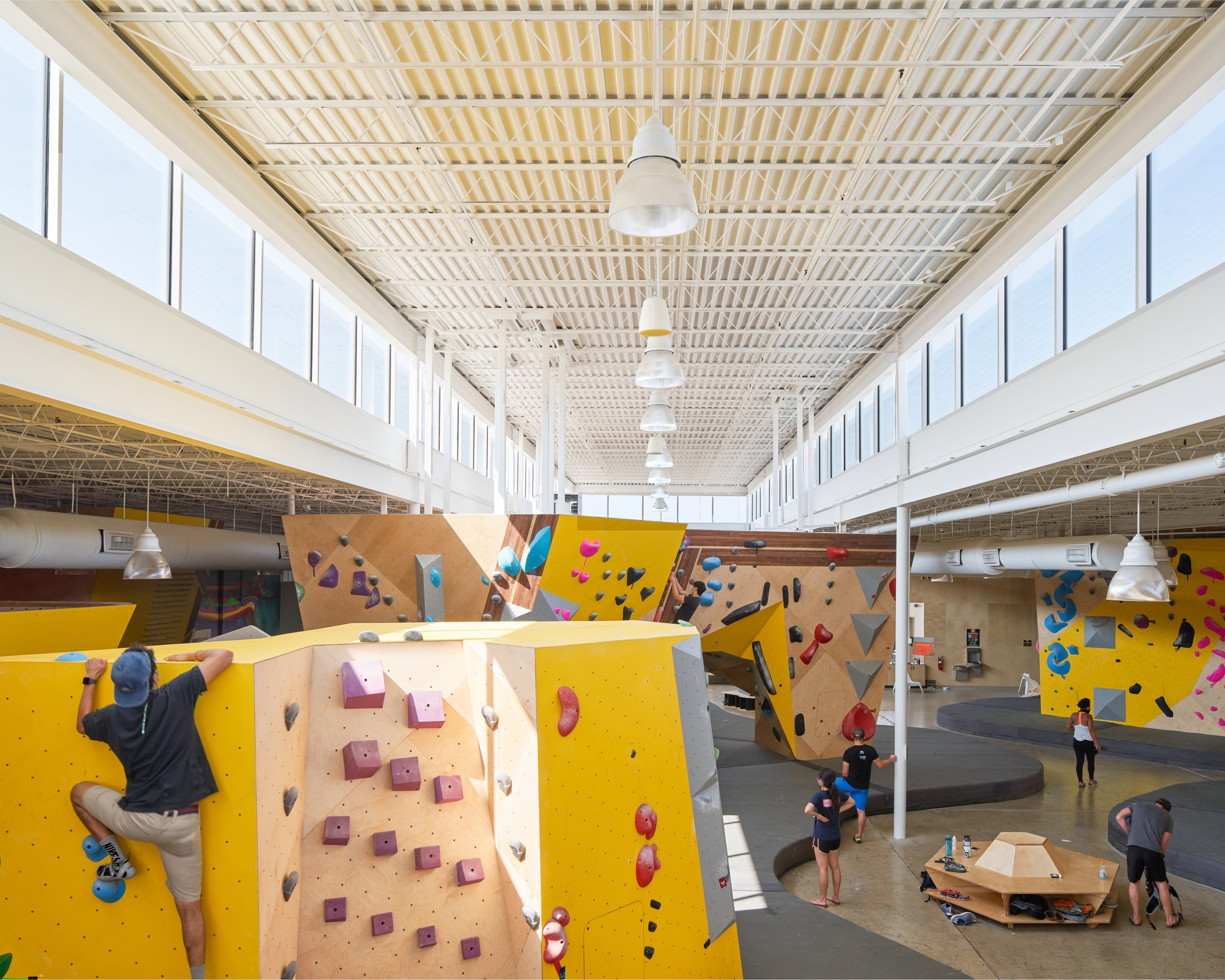An overhead view reveals Crux Central’s layout strategy—climbing zones arranged like sculptural islands beneath a continuous clerestory, emphasizing openness and daylight.