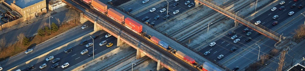 Aerial view of freight train travelling over the Connect 290 Blue multimodal corridor.