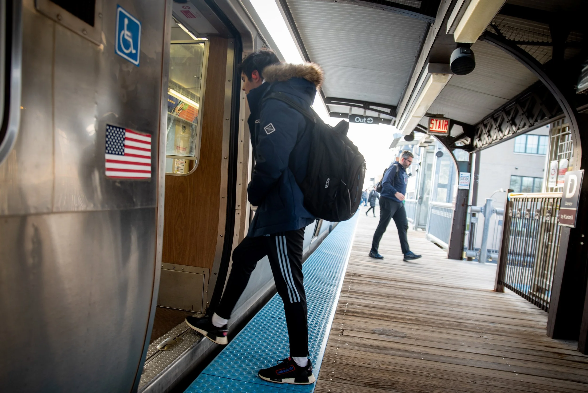A person steps onto a CTA Blue Line train along the Forest Park Branch.