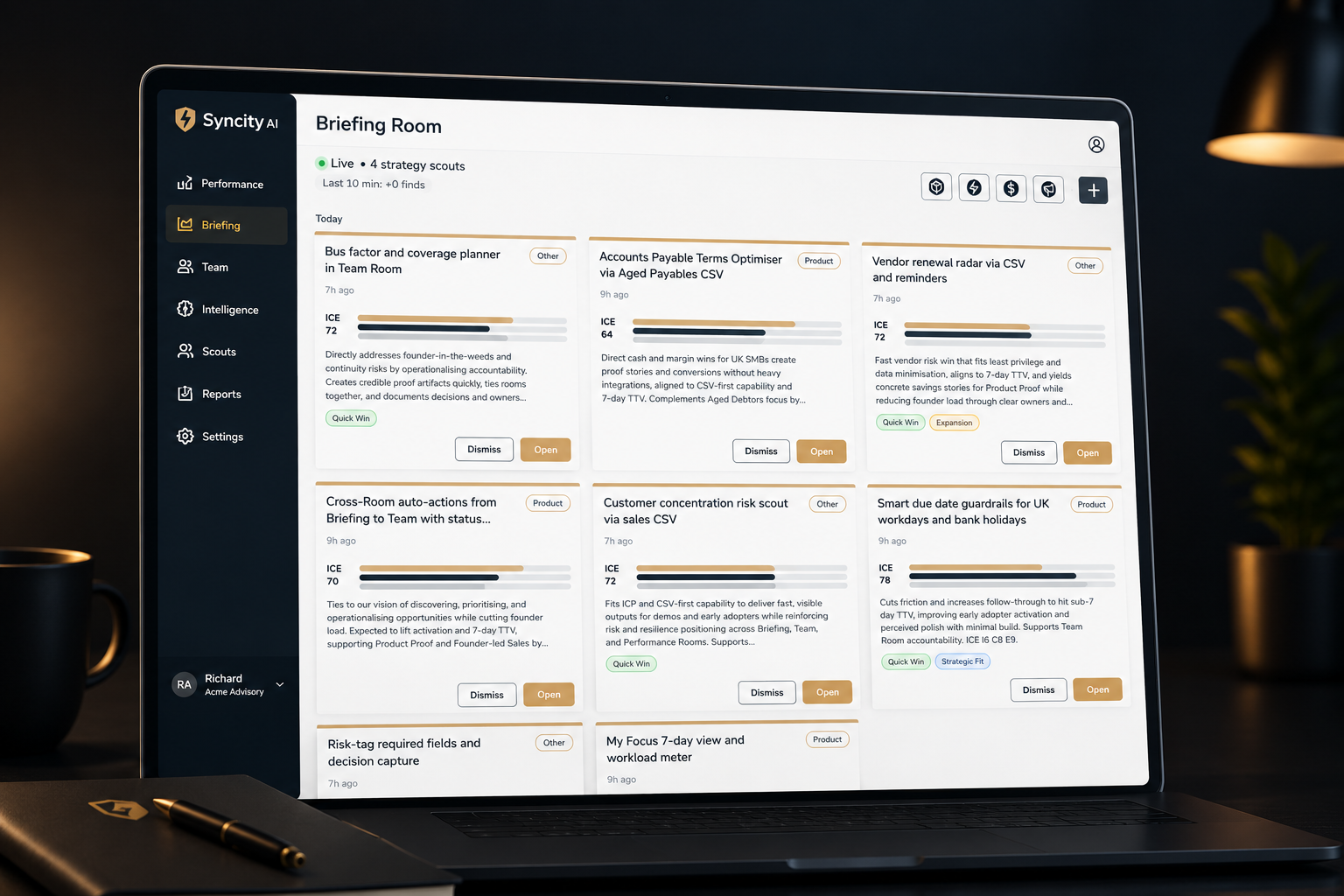 Laptop screen displaying a project management or team collaboration app named Syncty AI, showing a briefing room with cards for different tasks, their statuses, and details. The left sidebar includes navigation options such as Performance, Briefing, Team, Intelligence, Scouts, Reports, and Settings.