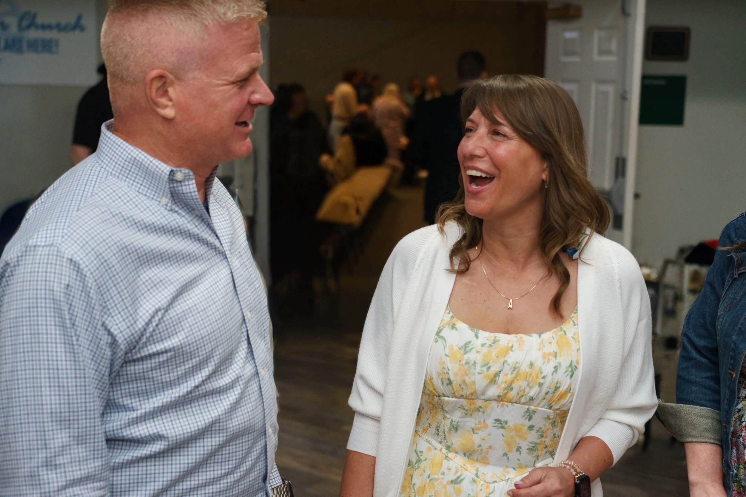 A married couple are smiling and talking to each other after church service at Victory Life Church in Stow, OH.