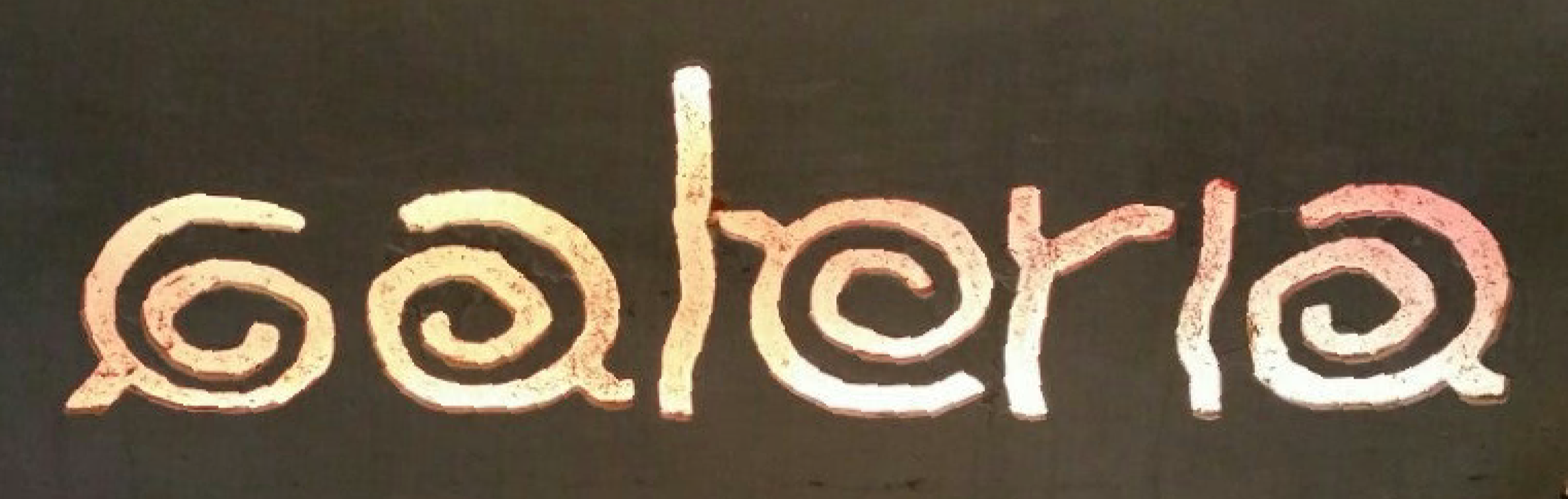 Sign with the word 'story' in stylized, spiral-like lettering.