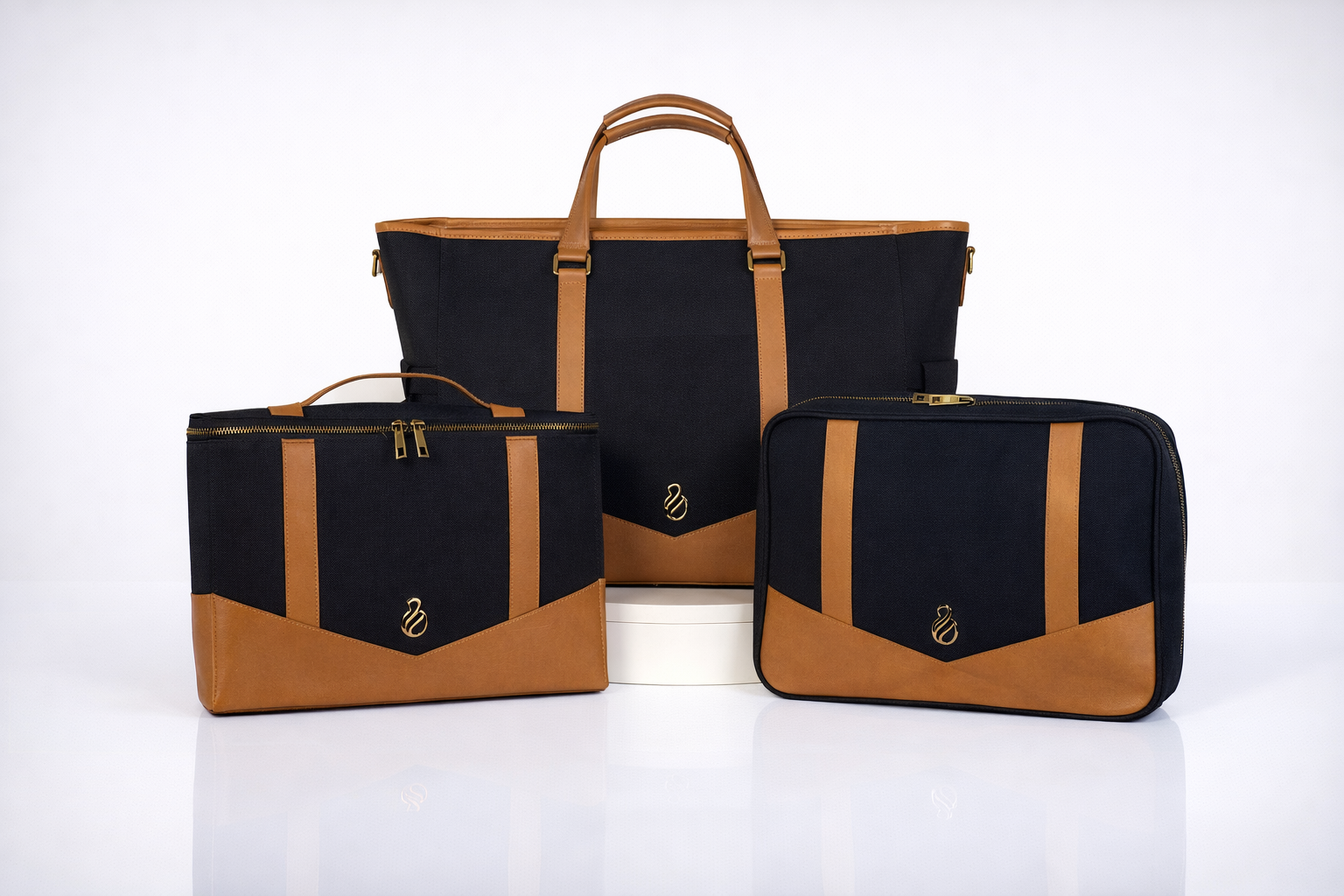 The Little Hauler modular parenting tote with interchangeable pods, shown in black coated canvas with leather trim