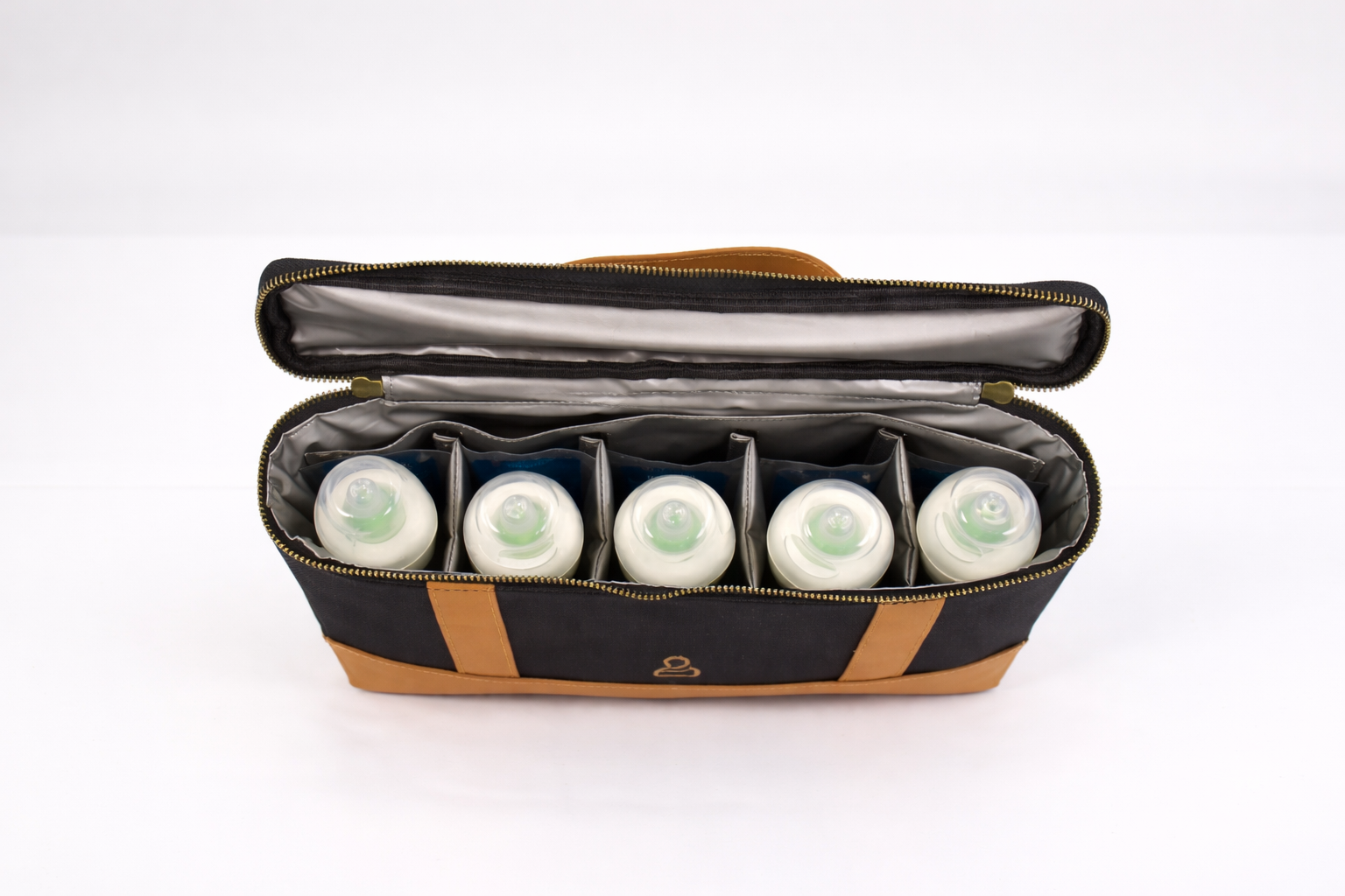  Interior of The Little Hauler Insulated Pod, part of the modular parenting system, with baby bottles and ice packs showcasing it's use as a bottle bag.