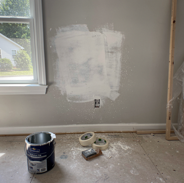 freshly sanded wall with paint roller and primer