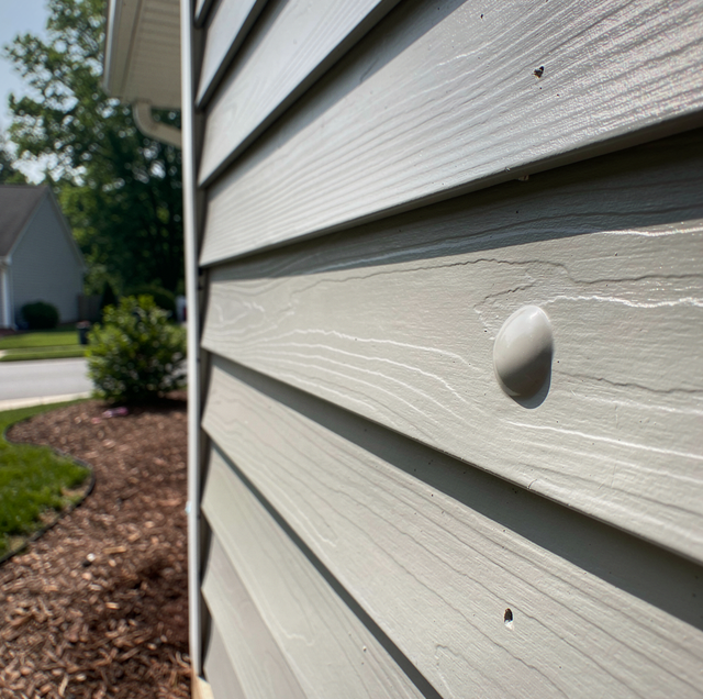 blistered exterior house paint bubbling into coin sized domes