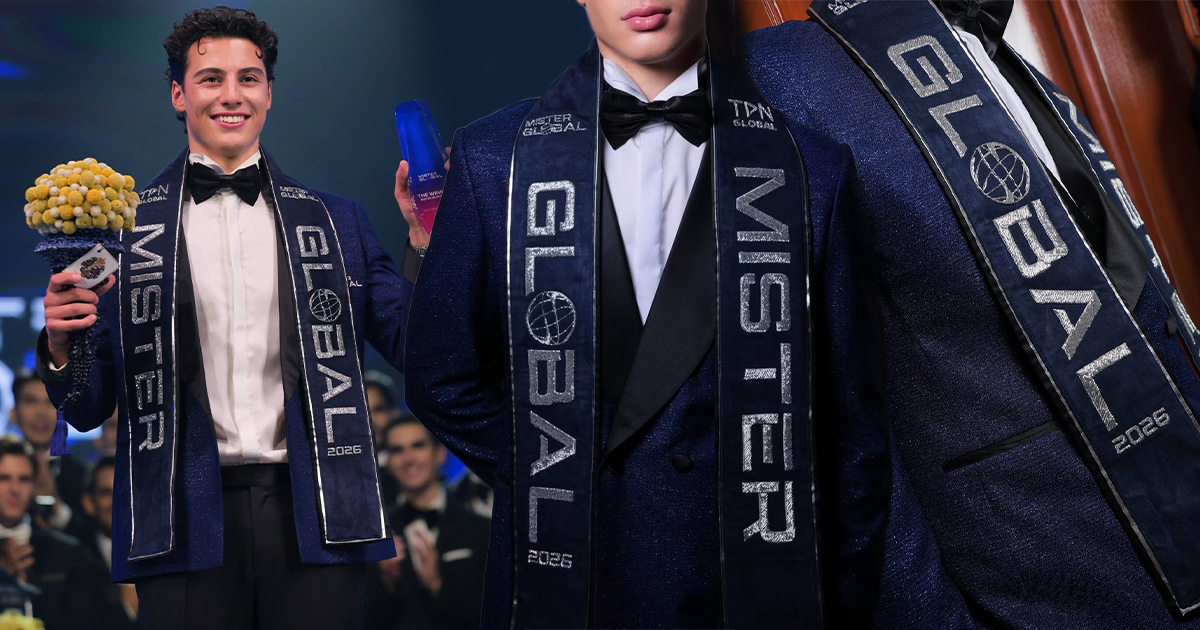Mister Global 2026 winner Dilhan Divrikli wearing a navy suede winner's sash designed by MAXY LALA, featuring silver hand-embroidered lettering.