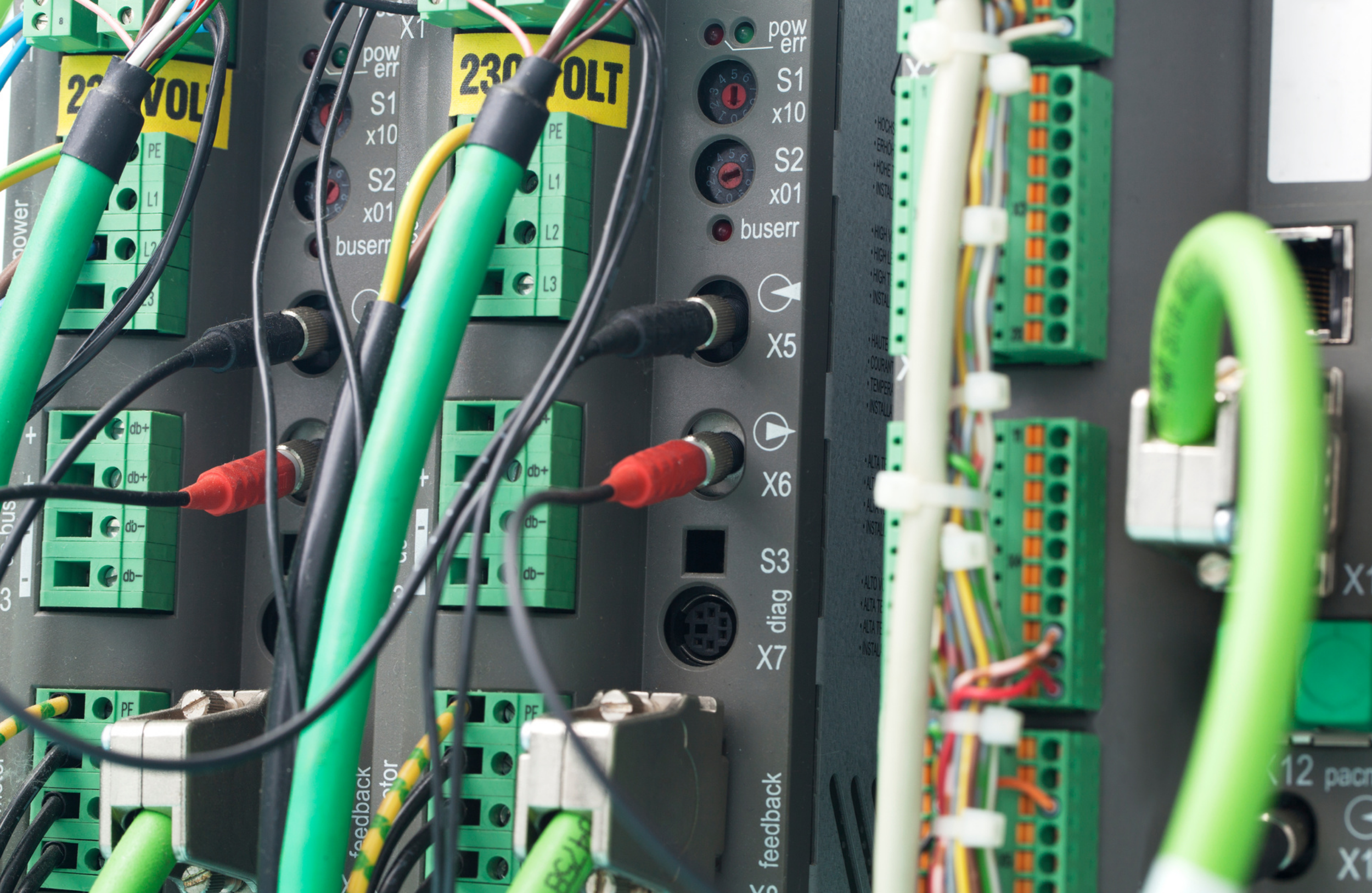 Close-up of electronic wiring and circuit panel with cables and connectors in a control unit or server.