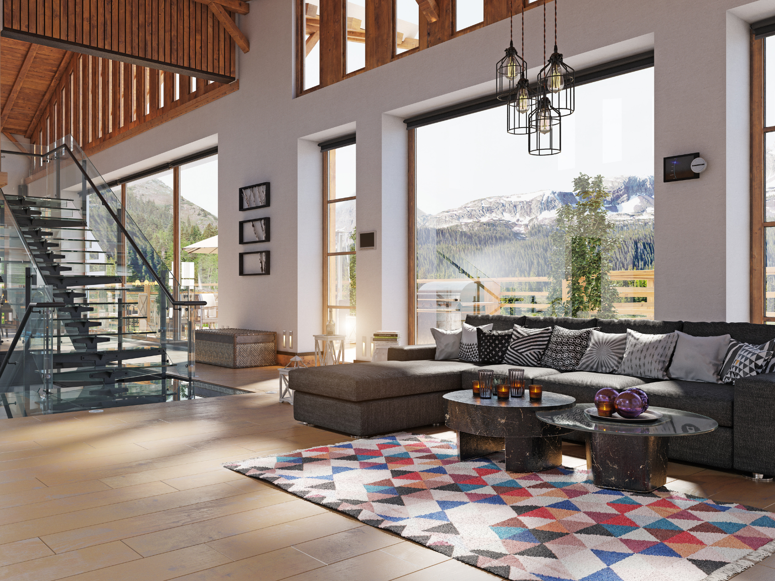 Living room with large windows showing mountain view, modern black sectional sofa with geometric-patterned pillows, multicolored geometric area rug, and two black coffee tables with decorative objects.