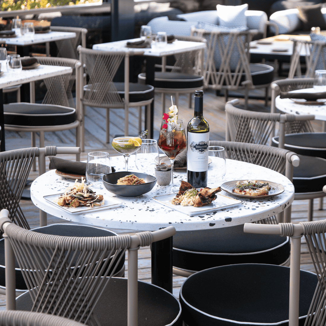 azara rooftop table with food spread.png