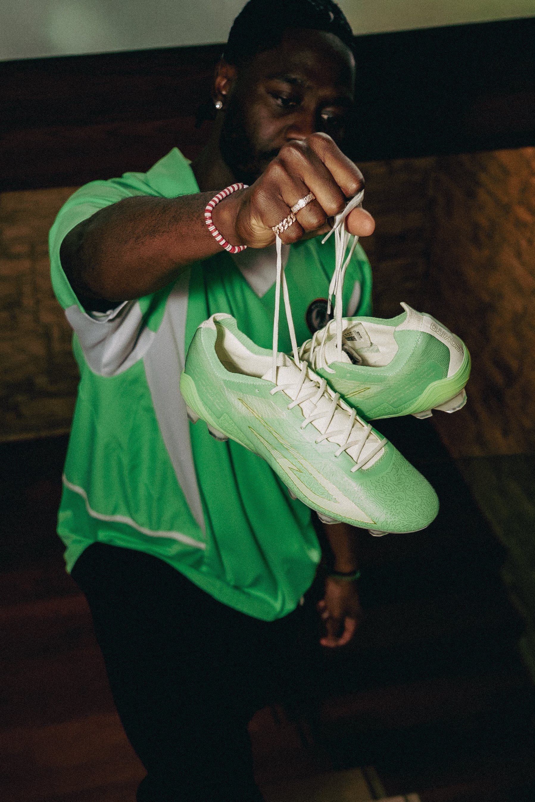 Ola Aina holding his signature soccer cleat. the sokito scudetta Mr Lulu