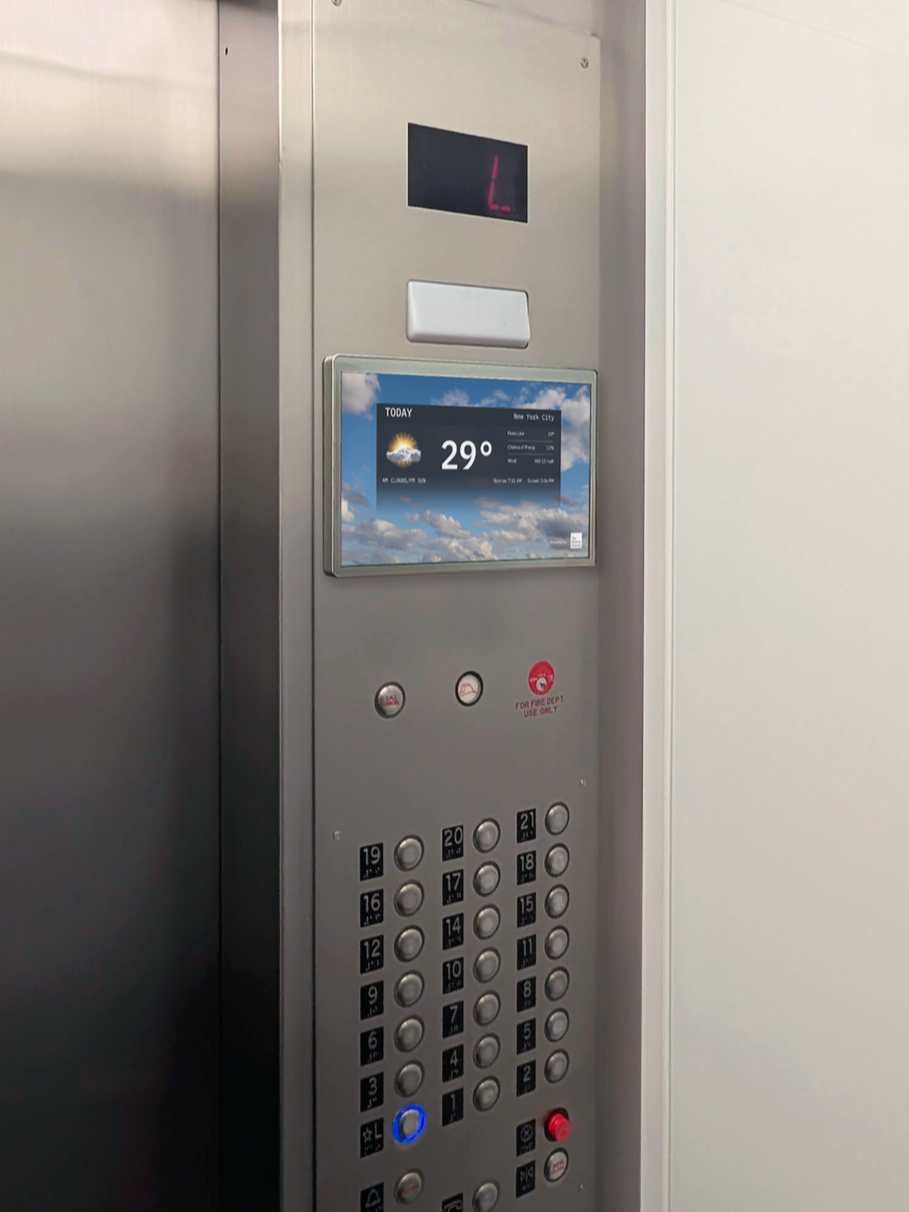 Small digital screen in an elevator, displaying the local weather forecast.