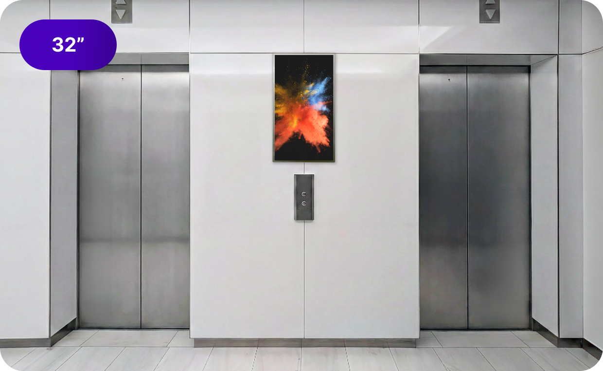 A 32 inch digital screen in an elevator bank.