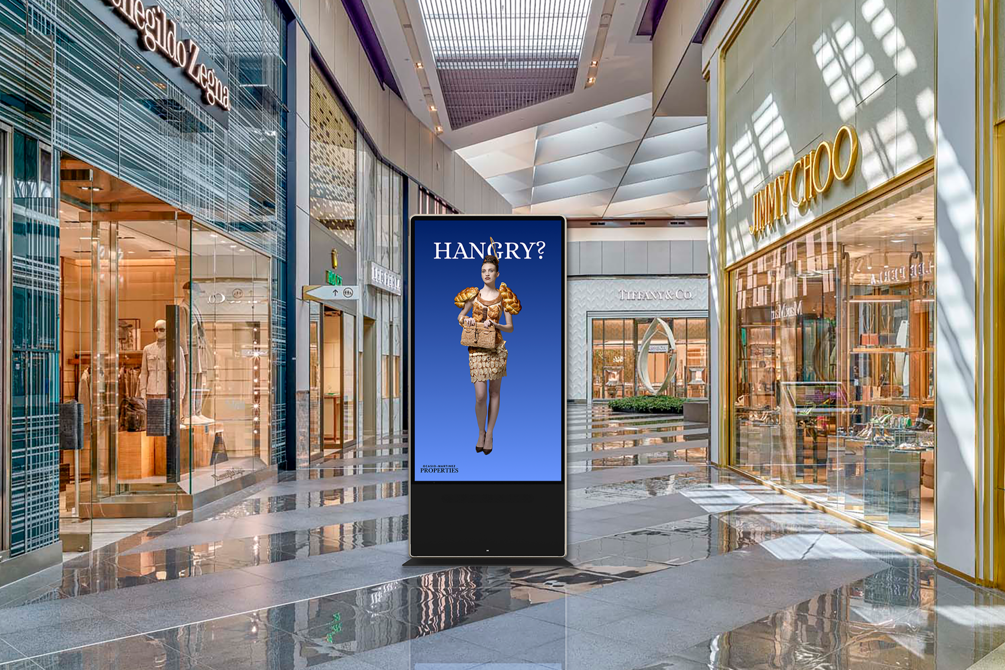 A large display kiosk in a retail mall, displaying local advertisement.