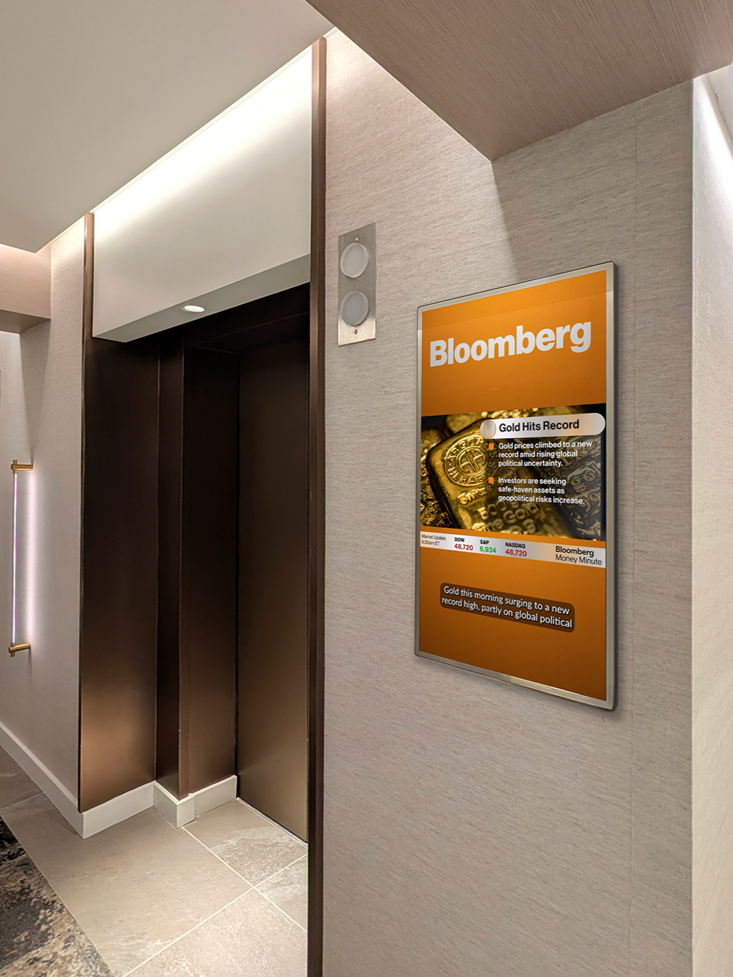 Digital screen next to an elevator in an office building hallway, displaying some market news from Bloomberg.