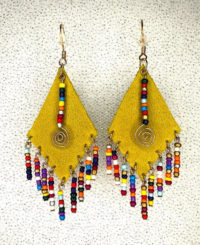 Colorful beaded earrings with yellow fabric backdrop and spiral metal details.