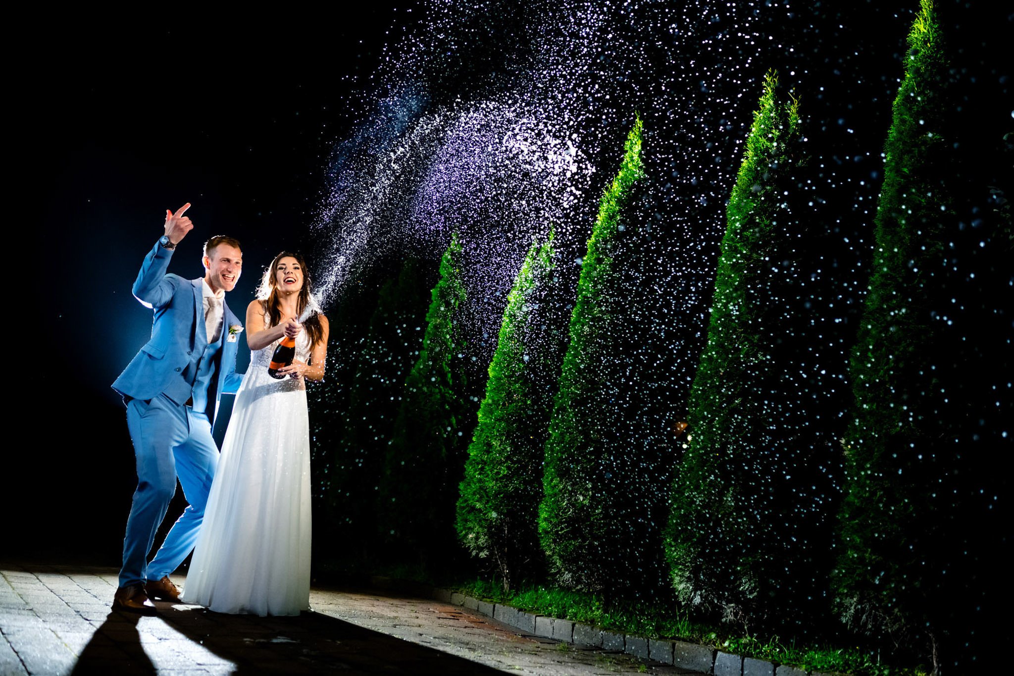 Average Wedding Costs in Winnipeg with bride and groom spraying champagne bottle