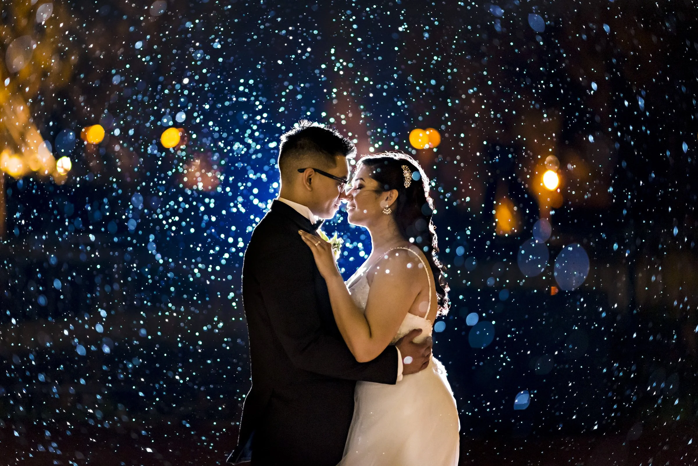 bride and groom in the rain about to kiss