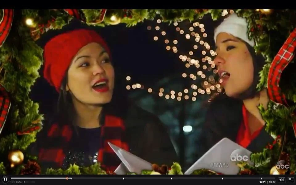 Marianne Cheng singing Christmas Music on ABC's What Would You Do with Sister, Cat Rakowski

Two women wearing Christmas hats and festive attire, talking and singing in a holiday setting with decorated Christmas wreath and lights.