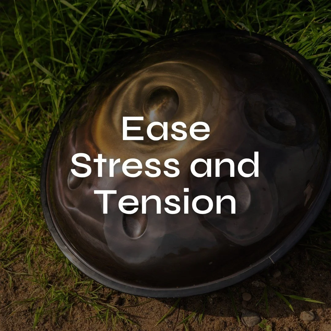 A handpan drum lying on the grass with the words 'Ease Stress and Tension' overlaid on it in white.